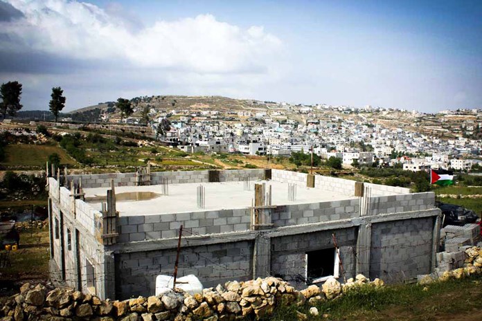 A half-built house on the outskirts of a refugee camp in Palestine.