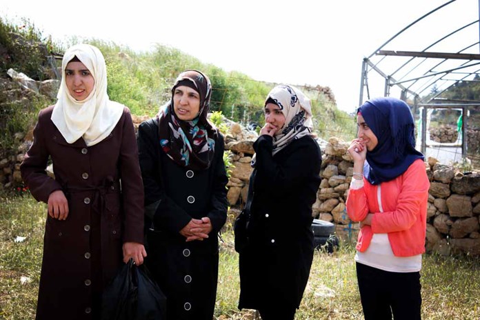 A family of women standing in their garden in Palestine.
