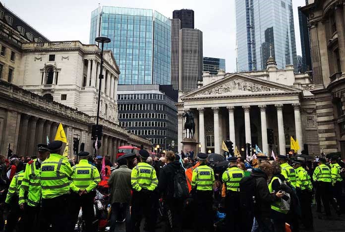 A Police cordon around Extinction Rebellion protestors outside the Bank of England in London.