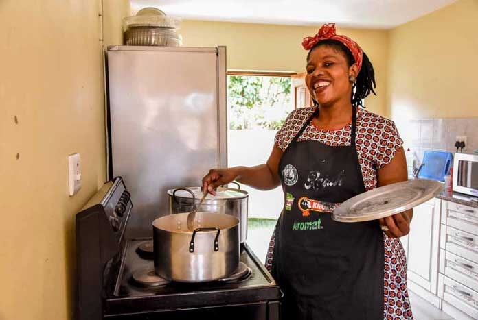 A women cooking for homeless young people at Umthombo in Durban, South Africa.