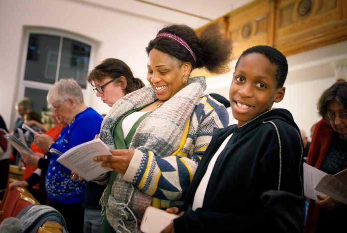 A boy and his mother enjoying a church service in West Yorkshire, England – December 2019