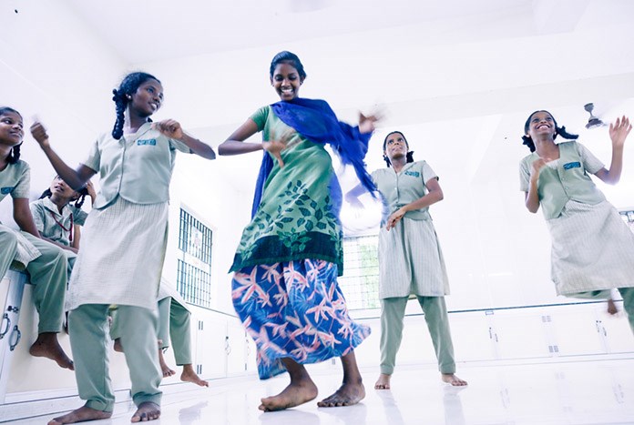 Girls at Karunalaya's shelter in Chennai, India dancing together.