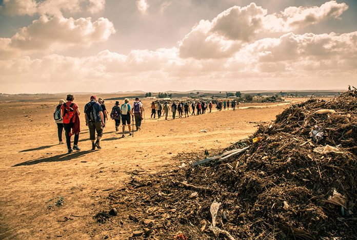 A large group of people walking through the Palestine Heritage Trail.