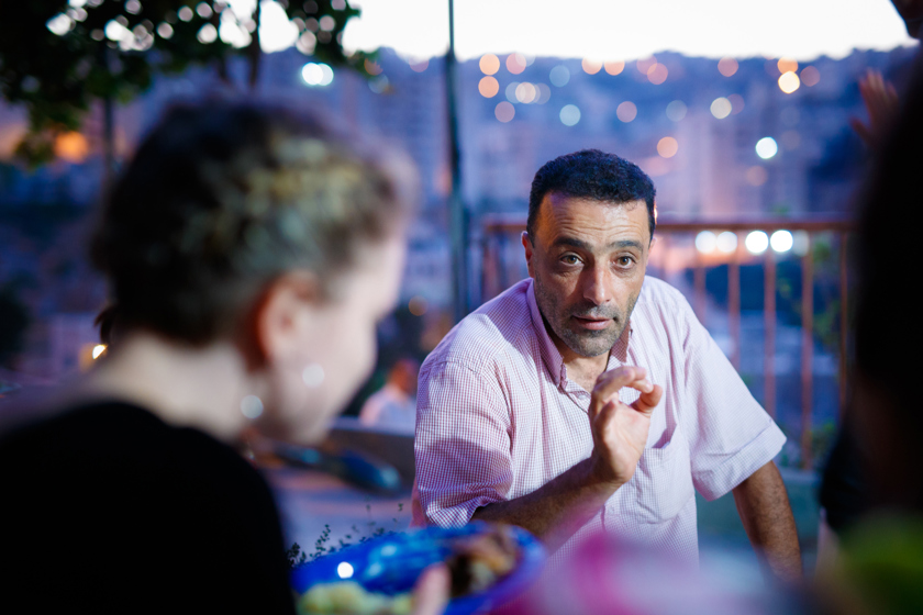 A Palestinian man speaking to a group of visitors from the UK.